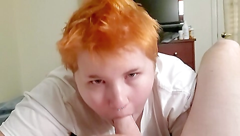 tattooed redhead deep throats her lover's hard cock